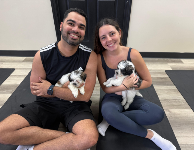 Puppy Yoga in Ann Arbor with her fiance - a favorite weekend activity.